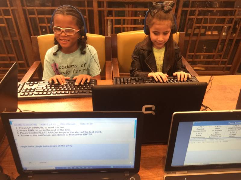 two Girl students having fun typing