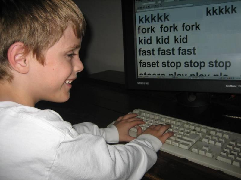 Photo of child typing on a Keyboard