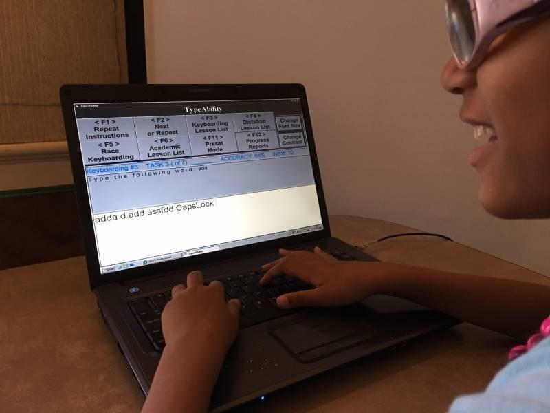 Image of student using a laptop to type